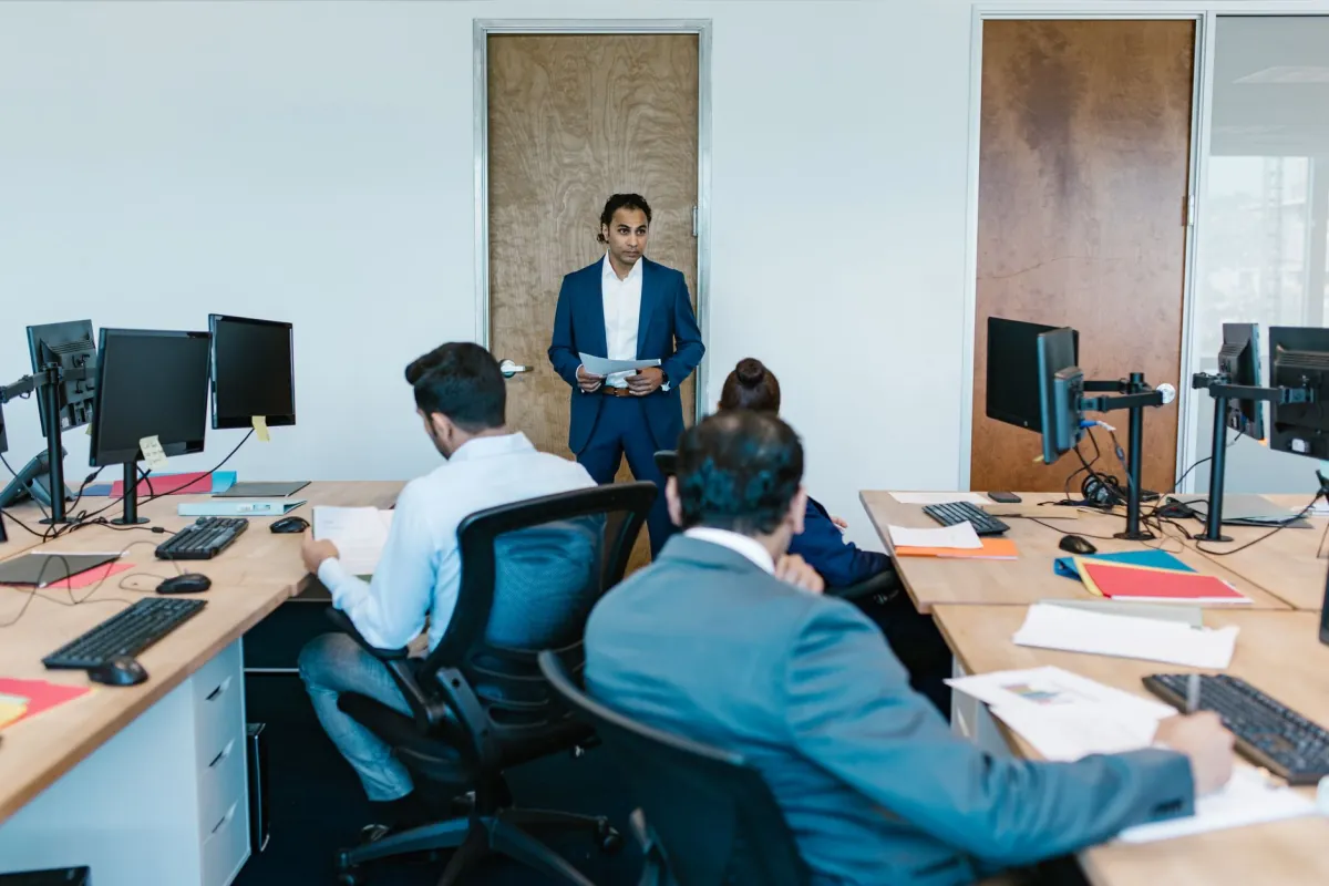Business meeting with diverse team in modern office space, discussing projects.